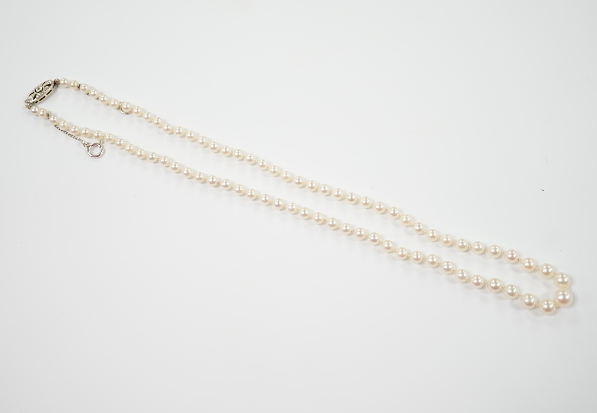 A single strand graduated cultured pearl necklace, with single stone diamond chip set 9ct white metal clasp, 46cm.